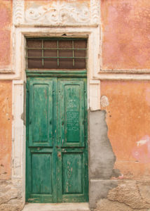 Sicily - Sunny impressions of the Aeolian Islands, also known as Aeolian Islands or Isole Eolie: Lipari, Stromboli, Salina, Vulcano, Panarea, Filicudi and Alicudi. Green wooden door in an old facade on Panarea. Sicily - Sunny impressions of the Aeolian Islands, also known as Aeolian Islands or Isole Eolie: Lipari, Stromboli, Salina, Vulcano, Panarea, Filicudi and Alicudi. Green wooden door in an old facade on Panarea.